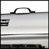 Close-up of the top of a silver appliance with a black handle and a black label. Anteprima dell’immagine prodotto
