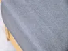 A close-up view of the textured gray fabric of a laundry basket, with a hint of the wooden frame visible on the left. Náhľad obrázku produktu