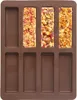 A brown silicone mold for making 8 rectangular bars, with three bars already filled with a granola-like mixture. Anteprima dell’immagine prodotto