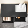 A top-down view of a dark gray bathroom vanity with two drawers. One drawer is open, revealing folded beige towels. The other drawer is also open, showing a small white container and a wooden dish with a round object. On the countertop, there is a white tr Podgląd zdjęcia produktu