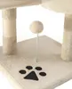 A close-up view of a beige cat tree with a paw print emblem and a dangling toy ball on a spring. Produktbild-Vorschau