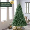 A decorated artificial Christmas tree in a room with windows and gifts. Produktbild-Vorschau