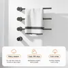 A black electric towel warmer mounted on a white wall with a white towel hanging on it. Below the towel warmer are three marketing icons with text describing its features. Produktbild-Vorschau