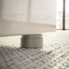 A close-up shot of a furniture foot on a patterned floor. Produktbild-Vorschau