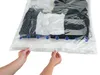 Hands closing a vacuum seal bag filled with clothes. Náhľad obrázku produktu
