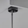 A close-up shot of a black furniture foot being screwed into a white surface, likely a cabinet or shelf. Produktbild-Vorschau
