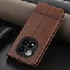 A brown leather phone case with a camera cutout is displayed on a dark surface with textured fabric in the background. Náhled obrázku produktu