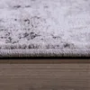 A close-up view of the edge of a rug on a wooden floor. Produktbild-Vorschau