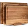 A set of three wooden cutting boards stacked on a wooden holder. Produktbild-Vorschau