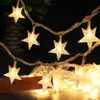 A string of star-shaped fairy lights with a warm, white glow. Anteprima dell’immagine prodotto