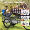 A family is having a picnic outdoors with a bicycle trailer in the foreground. Produktbild-Vorschau
