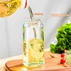 Oil being poured into a glass bottle, with salad in the background. Produktbild-Vorschau