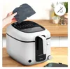 A hand is shown inserting a filter into a white and black Tefal deep fryer on a wooden countertop. Produktbild-Vorschau