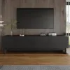 A modern black media console with a minimalist design is positioned against a wood-paneled wall. A large black television is mounted above the console. The console features four doors with subtle circular inlays and stands on slender black legs. Decorative Náhľad obrázku produktu