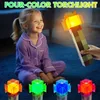 A young girl in pajamas is sitting on the floor, looking at a pixelated torchlight held by an adult's hand. Four smaller torchlights are displayed in front of her. Náhled obrázku produktu