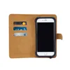 A brown leather wallet-style phone case with a phone inserted and credit cards in the slots. Produktbild-Vorschau