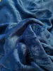 A close-up view of a crumpled blue plush fabric. Produktbild-Vorschau