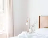 A bedroom scene with a bed, nightstand, and lamp. Produktbild-Vorschau