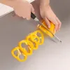 Hands slicing a yellow bell pepper on a stainless steel cutting board. Produktbild-Vorschau