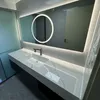 A modern bathroom vanity with a sink, faucet, and a large illuminated mirror. Anteprima dell’immagine prodotto