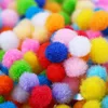 A close-up, overhead view of a pile of colorful pom-poms. Produktbild-Vorschau