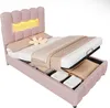 A pink upholstered bed with a built-in storage compartment, shown with the mattress lifted to reveal the storage space. The headboard has integrated LED lighting. Produktbild-Vorschau