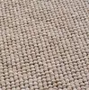 A close-up view of a beige bouclé carpet texture. Podgląd zdjęcia produktu