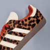 A close-up view of the side of an Adidas Samba OG sneaker with a leopard print pattern. Podgląd zdjęcia produktu