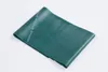 A green TheraBand exercise band is shown lying on a white background. Produktbild-Vorschau
