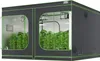 A grow tent with plants inside, illuminated by grow lights. Anteprima dell’immagine prodotto