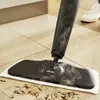 A steam mop cleaning a tiled floor. Podgląd zdjęcia produktu