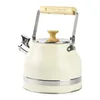 A cream-colored kettle with a wooden handle and lid knob, set against a white background. Náhled obrázku produktu