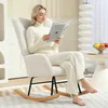A woman is reading a book while sitting in a rocking chair in a living room. Anteprima dell’immagine prodotto