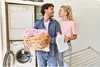 A couple is doing laundry together in a laundry room. Produktbild-Vorschau