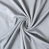 A close-up, top-down view of a light gray fabric swatch, swirled into a spiral. Produktbild-Vorschau