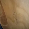A close-up view of the wood grain and texture of a table. Produktbild-Vorschau