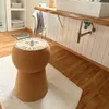 A cork stool shaped like a champagne cork in a bathroom setting. Produktbild-Vorschau