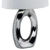 A close-up of a modern table lamp with a silver-grey ceramic base and a white fabric shade. Náhled obrázku produktu
