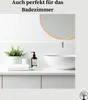 A clean and modern bathroom vanity with a sink, faucet, soap dispenser, plant, and folded towels. Produktbild-Vorschau