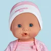 Close-up of a Nenuco Sara doll's face, wearing a pink and white striped hat and shirt, with tears streaming from its eyes. Produktbild-Vorschau