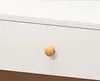 A close-up of a white drawer with a round wooden knob. Náhľad obrázku produktu
