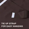 A close-up of a brown fabric curtain with a white velcro strap and text indicating it's a tie-up strap for easy hanging. Náhled obrázku produktu