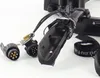A close-up view of a black bicycle rack accessory, including electrical connectors and straps, against a white background. Voir les images du produit