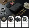 A flat lay of a wallet, cards, coins, headphones, and a key on a black surface. Produktbild-Vorschau
