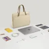 A laptop bag and accessories are arranged on a white surface. Náhľad obrázku produktu