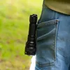 A person's hip and pocket with a flashlight clipped to it. Podgląd zdjęcia produktu
