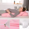 A pregnant woman is sleeping on a bed, using a U-shaped pregnancy pillow. The collage also shows close-ups of the pillow's fabric and filling. Produktbild-Vorschau