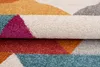A close-up, folded view of a colorful geometric patterned rug. Náhled obrázku produktu