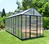 A greenhouse set up on a lawn with trees and a hill in the background. Náhled obrázku produktu