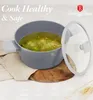 A gray pot filled with soup sits on a wooden board, with a glass lid to the side. Text overlays highlight healthy cooking. Podgląd zdjęcia produktu